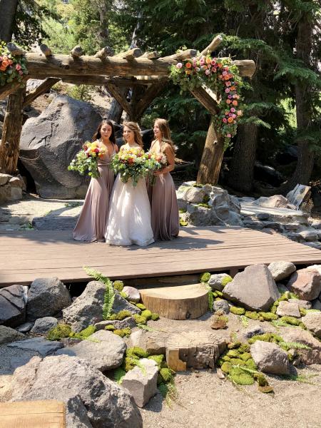 Pink, orange roses  with moss and greenery  at Forest  Chapel Mammoth Lakes 