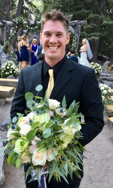 Best man is holding the bride bouquet at Forrest Chaple 