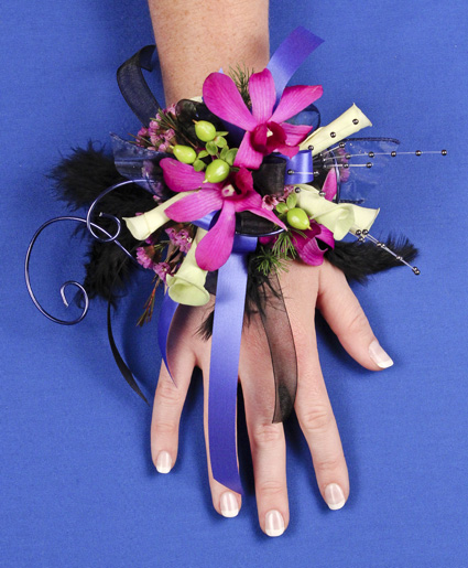 This prom corsage is so fun with the purple flowers, ribbon, wire and feathers.